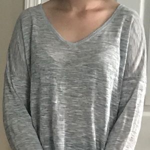 A long sleeved gray shirt by Feel The Piece.